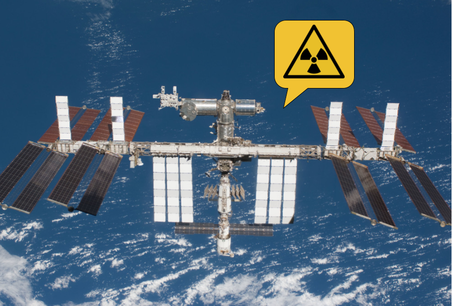 La estación espacial internacional y un bocadillo con el símbolo del trébol radiactivo indicando presencia de radiación ionizante.